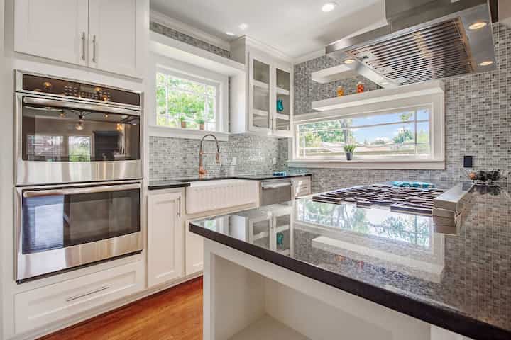 An image of a modern kitchen with sleek appliances, featuring a gas stove, refrigerator, and built-in microwave in League City